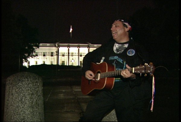 Craig singing passionately in front of the White House, leading the parents & families with missing and abducted children in song